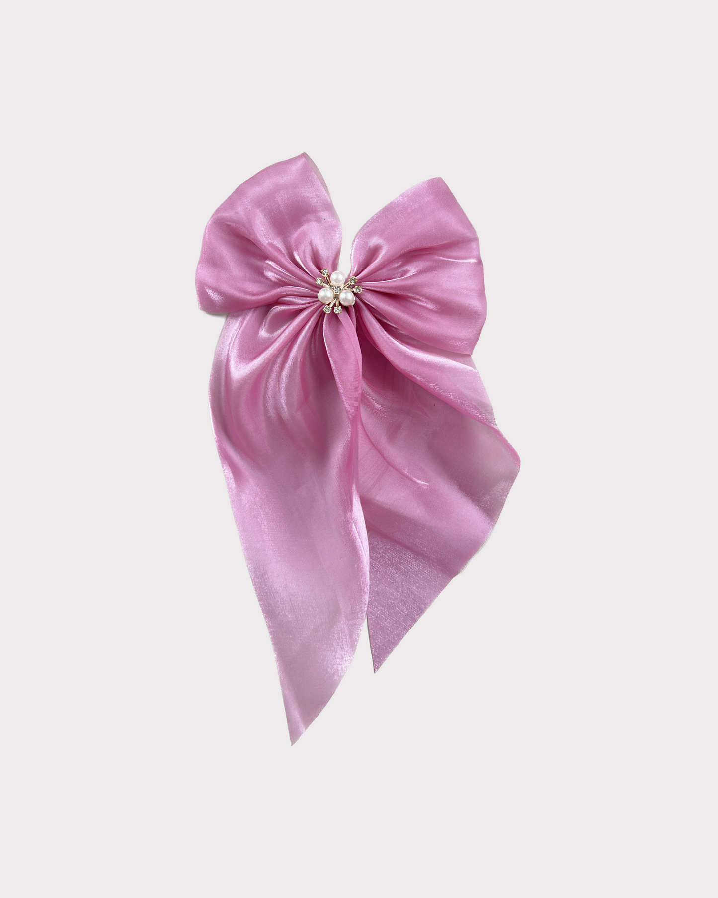 Elegant pink bow with a glittering stones and pearls center adds a beautiful accent to any hairstyle. Ideal for all ages and occasions.