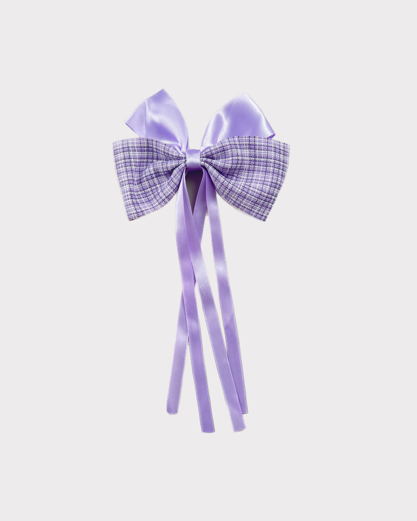Elegant violet or purple bow with checkered design paired with flowing satin ribbons adds a beautiful accent to any hairstyle. Ideal for all ages and occasions.