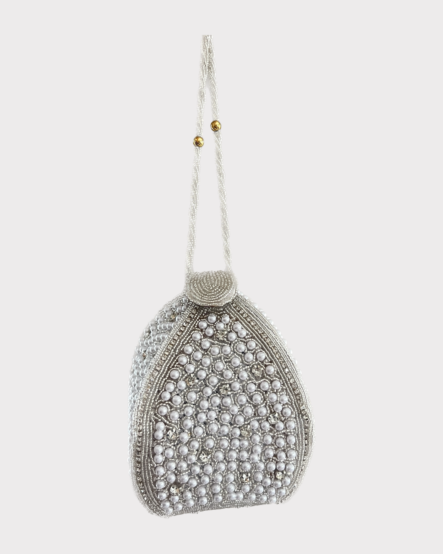 premium lotus shaped silver white colored potli or clutch or purse bag in high quality fabric with pearls, crystal rhinestones and beads work with handle and securely locking magnet in an attractive pattern by Oviya